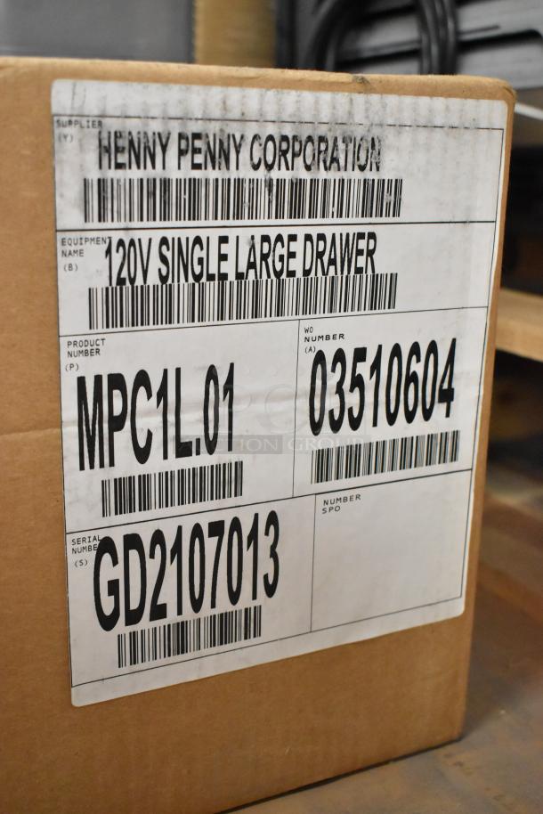 Brand new Henny Penny MPC1L.01 stainless steel holding bin, 120V, 1 phase. Scratch and dent condition. Box label visible.