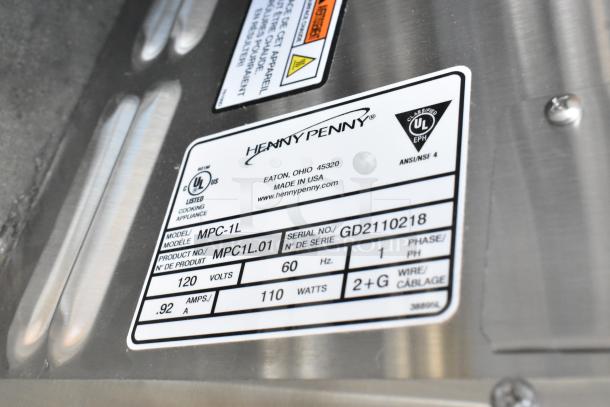 Henny Penny MPC-1L stainless steel holding bin label, shows 120V, 60Hz, single phase, model and serial numbers, brand logo.