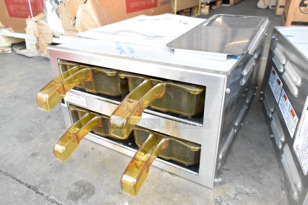 2 Henny Penny MPC-1L stainless steel modular holding bins, new condition, 120V, 1 phase; features gold handles.