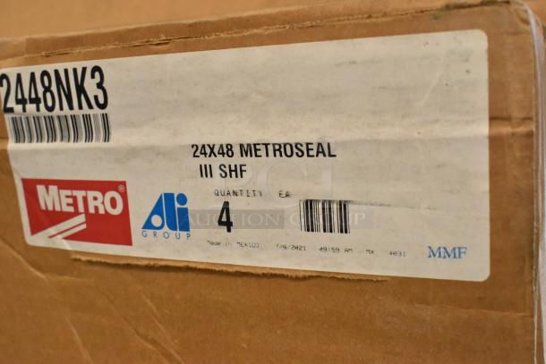Two brand new boxes of Metro 2448NK3 epoxy-coated wire shelves, 48"W x 24"D. Includes labels with product details.