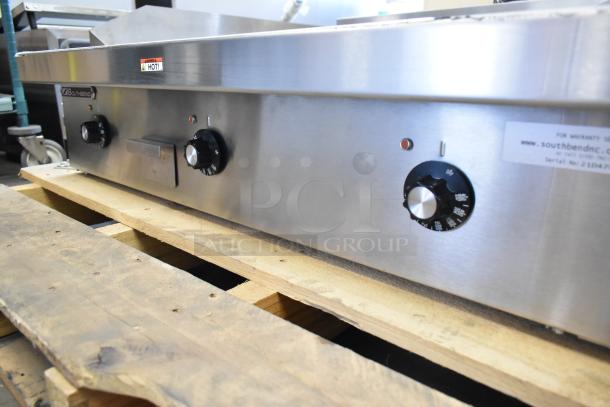 Brand new Southbend PE36N-TTT stainless steel commercial electric griddle, 208V, 1 phase, with control knobs, on pallet.