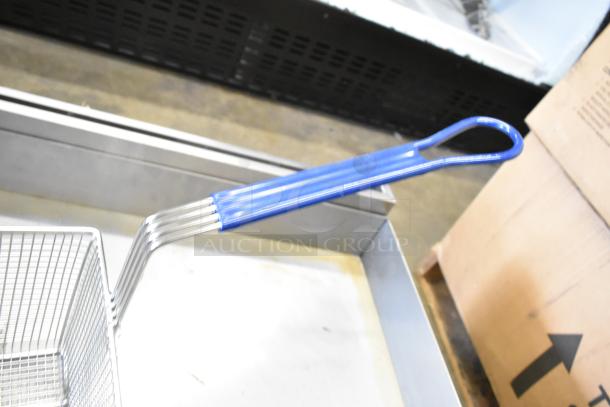 Brand new metal fry basket with blue handle, in box. Ideal for kitchen use, durable wire mesh construction.