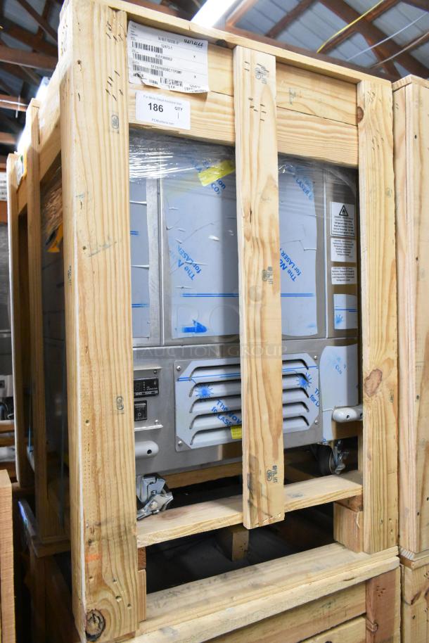 BKI 52473-1 stainless steel commercial meat freezer in crate. Brand new, on casters, 115V, 1 phase. Tags visible.