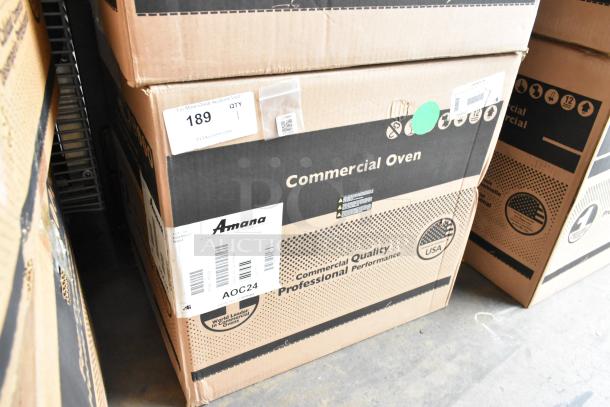New Amana AOC24 stainless steel commercial microwave in box. Features touch pad, 208-240V. Model marked on box.