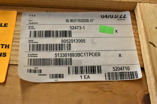 Brand new BKI 52473-1 stainless steel commercial meat freezer label in crate, showing model, serial, and condenser numbers.