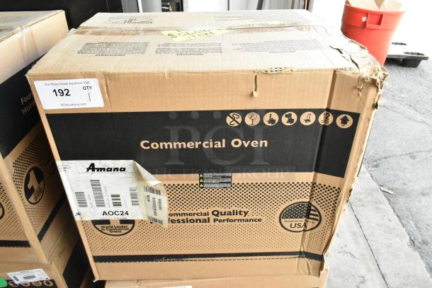 Brand new Amana AOC24 stainless steel commercial microwave in box, touch pad, 208-240V, packaging intact.