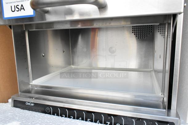 Brand new 2021 Amana AOC24 stainless steel commercial microwave, touch pad, 208-240V, USA-made label visible.