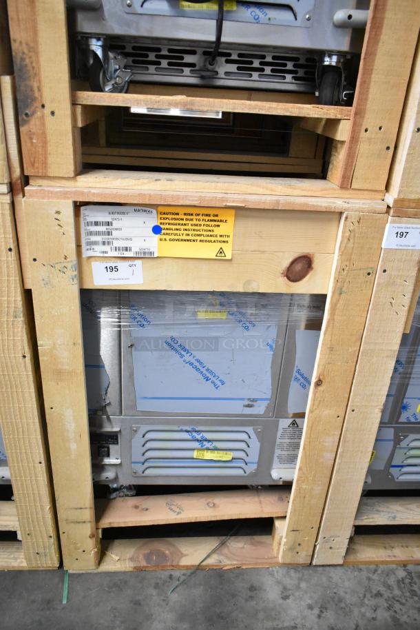 Brand new BKI 52473-1 stainless steel commercial meat freezer, in crate, on casters, 115V, 1 phase with safety labeling.