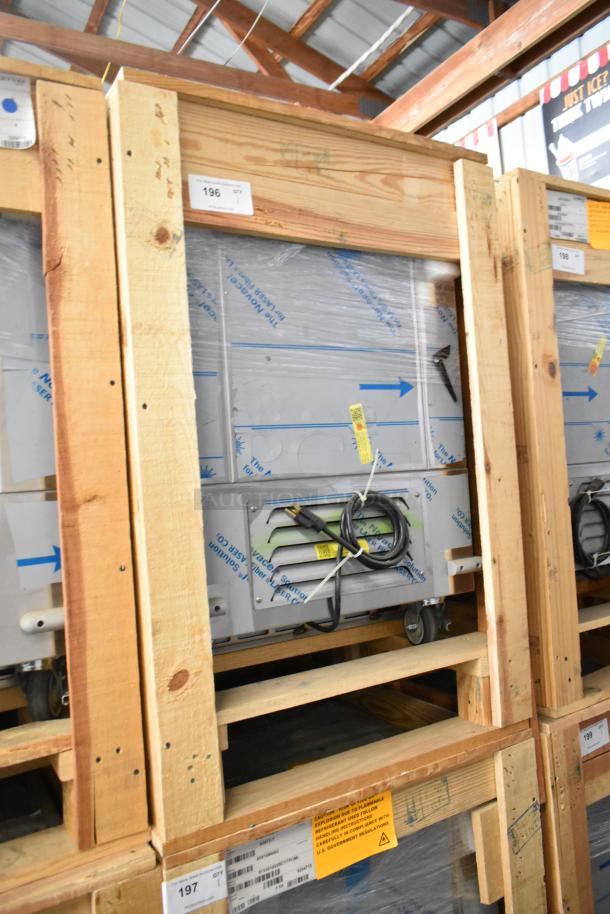 Brand new BKI 52473-1 stainless steel commercial meat freezer in crate, on casters, 115V, 1 Phase, with visible tags and labels.
