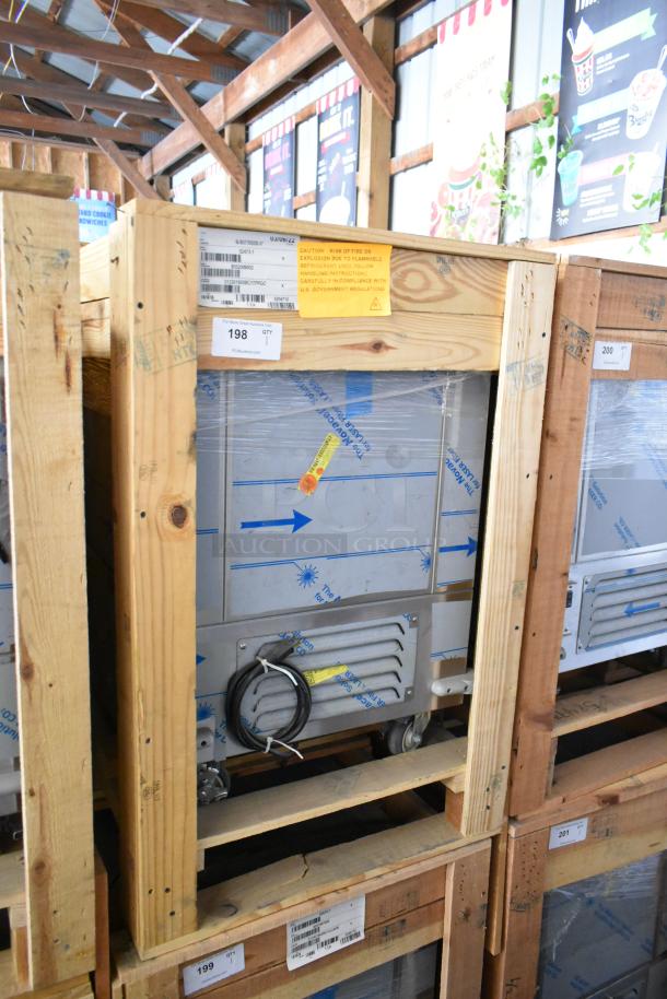 Brand new 2022 BKI 52473-1 stainless steel meat freezer in crate, on commercial casters. Tags show 115V, 1 phase.