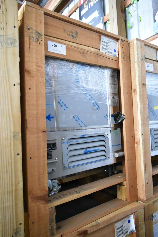 Brand new BKI 52473-1 stainless steel commercial meat freezer in crate, on casters, 115V, 1 phase, visible labels.