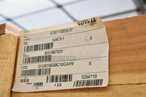 Brand new BKI 52473-1 stainless steel commercial meat freezer with caster wheels, 115V, 1 phase, tag shows model and serial numbers.