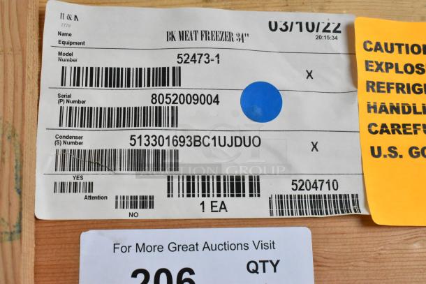 Alt text: BKI 52473-1 Stainless Steel Commercial Meat Freezer label on crate, showing model, serial, and condenser numbers.