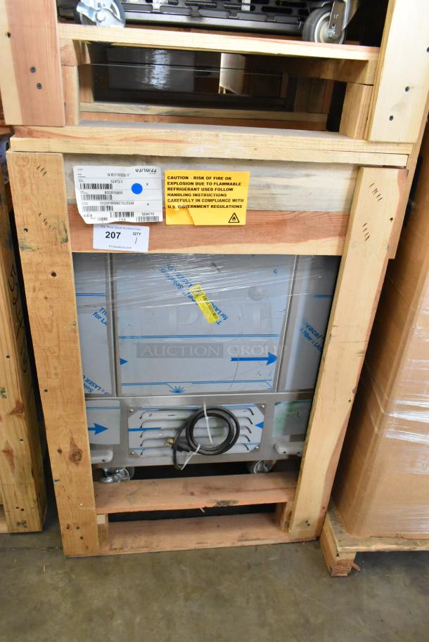 Brand new BKI 52473-1 stainless steel commercial meat freezer on casters, in crate. 115V, 1 phase, label visible.