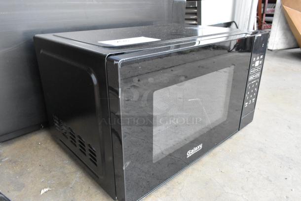 Brand new Galaxy 177MW900D0A microwave, black, push button controls. Scratch and dent model. 120V, 1 phase.