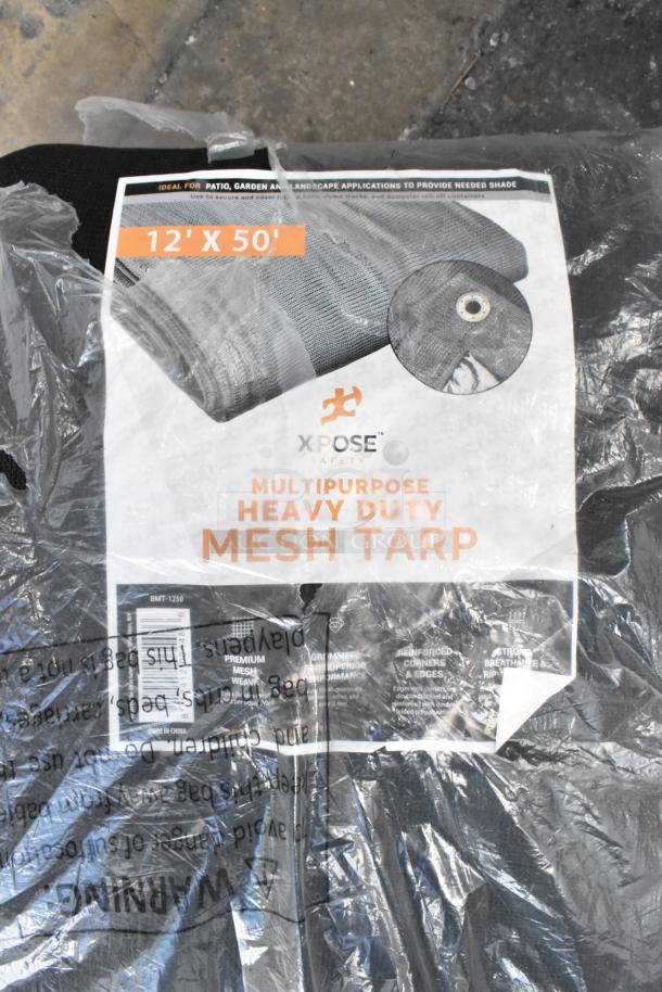 Brand new Xpose BMT-1250 12' x 50' black heavy-duty weatherproof mesh tarp in packaging, with eyelet detail visible.