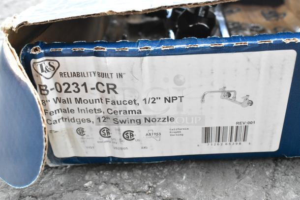 Cardboard box labeled "T&S B-0231-CR" containing a wall mount faucet with 1/2" NPT female inlets and 12” swing nozzle. Box is slightly damaged.
