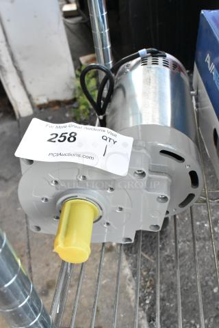 Brand new Hengyi HY-349 motor, 120 volts, 1 phase. Scratch and dent condition, yellow protective cap on shaft. Auction tag visible.