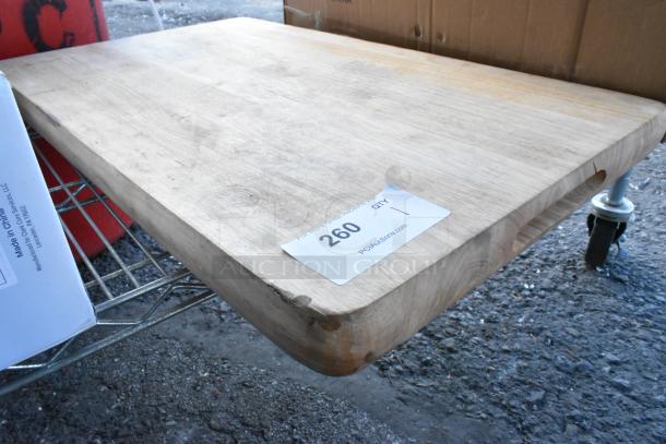 Brand new wooden cutting board with scratch and dent, rectangular shape, visible grain, and auction sticker “260 QTY 1”.