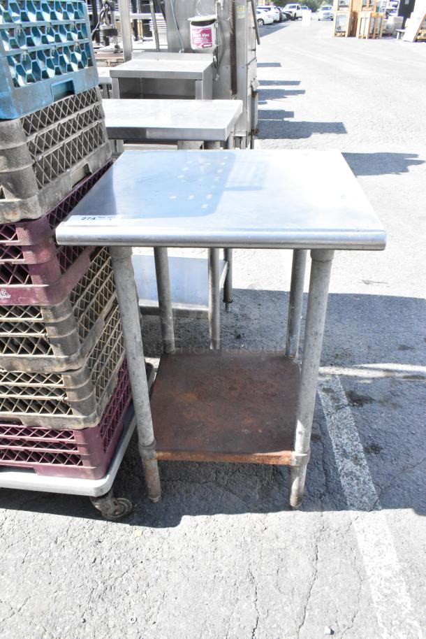 Stainless steel table with metal under shelf, showing slight rust on shelf, durable legs, suitable for kitchen or workshop.