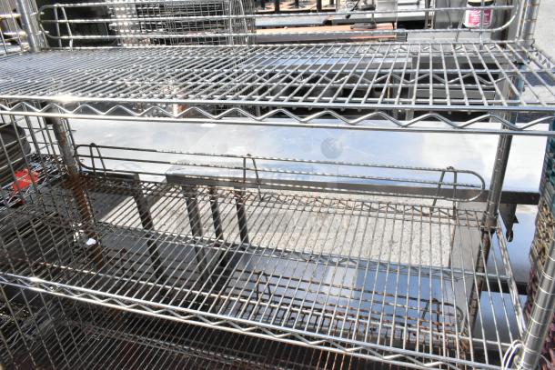 Chrome finish 6 tier wire shelving unit on commercial casters. Buyer must dismantle. Ideal for heavy-duty storage.