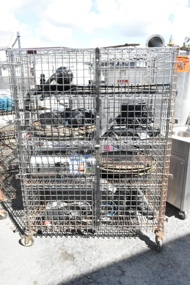 Chrome finish 5-tier wire shelving unit with liquor cage on commercial casters. Includes contents. Buyer must dismantle.