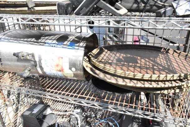 Chrome finish 5-tier wire shelving unit with liquor cage, contents, on commercial casters. Buyer must dismantle.
