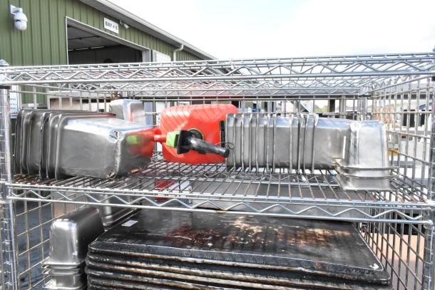 Chrome 5-tier wire shelving unit on casters with liquor cage, includes food warmer, stainless bins. Buyer to dismantle.