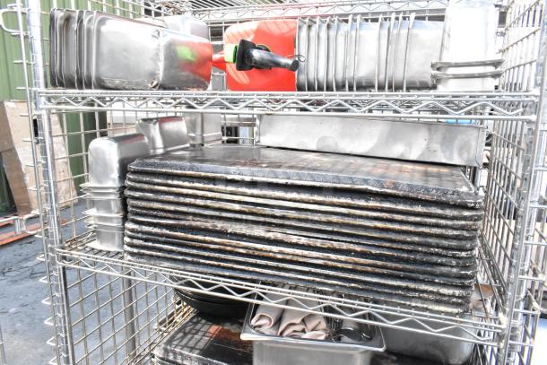 Chrome 5-tier wire shelving unit on casters with liquor cage, food warmer, stainless bins; buyer dismantles.