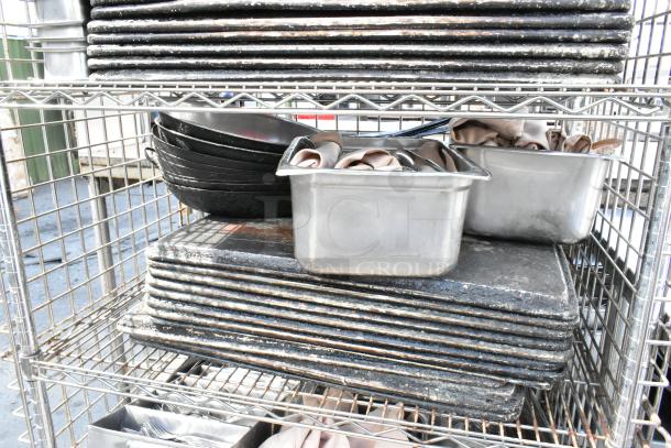 Chrome 5-tier wire shelving on wheels with liquor cage. Includes food warmer, stainless steel bins. Buyer dismantles.