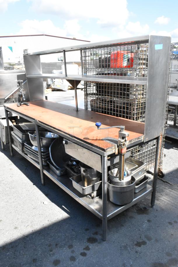 Stainless steel table with commercial can opener, 2-tier over shelf, under shelf, and drop-in bins; includes various contents.