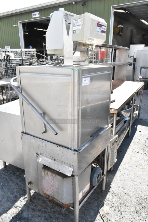 Hobart stainless steel commercial pass-through dishwasher, visible wear, with model label and operation instructions on top.