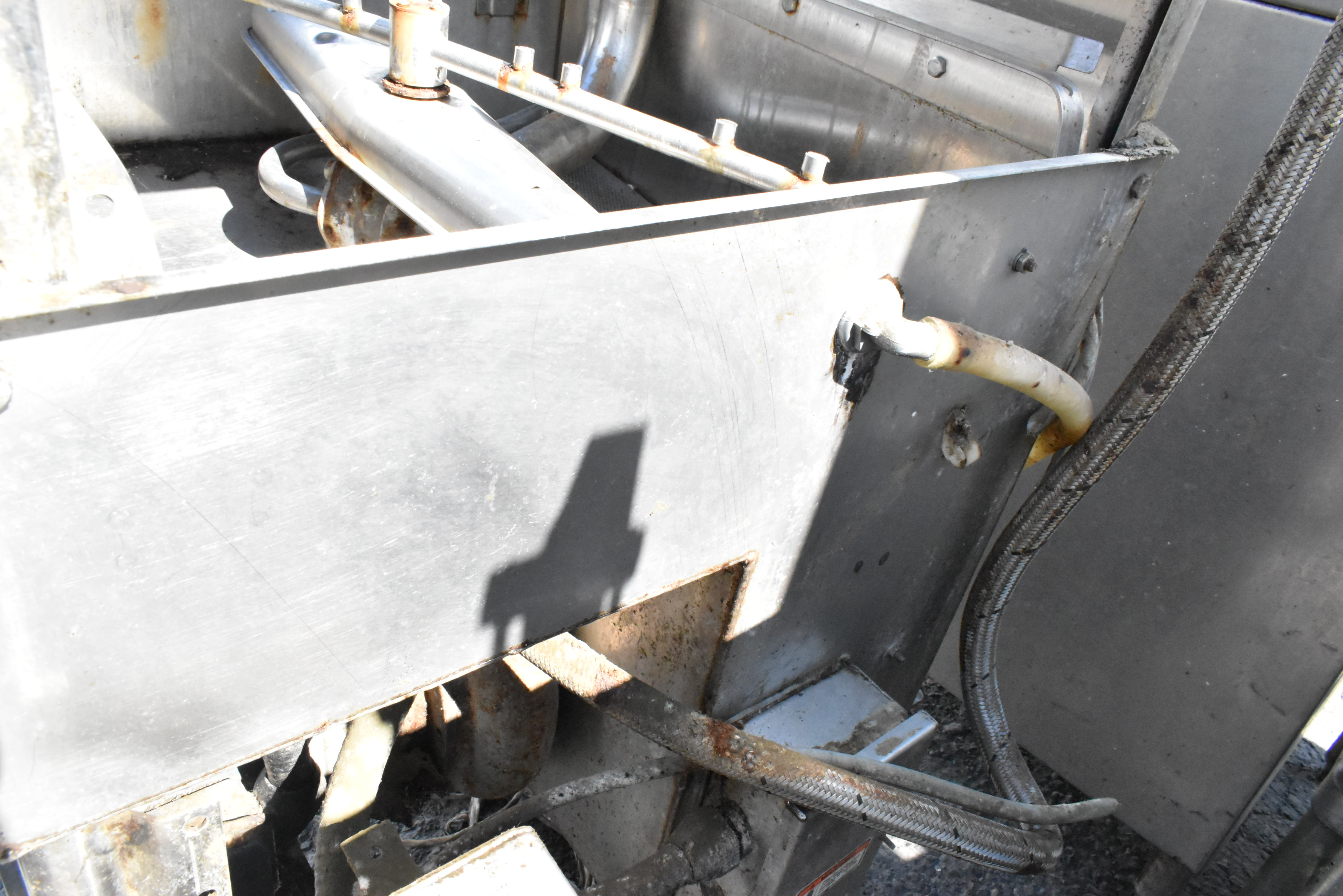 Interior spray arm showing rust and hard water residue buildup