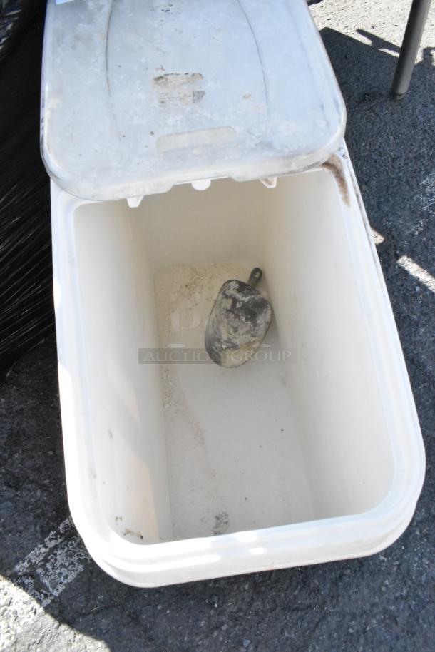 White poly ingredient bin on commercial casters, open lid showing interior. Slightly worn condition with visible residue.