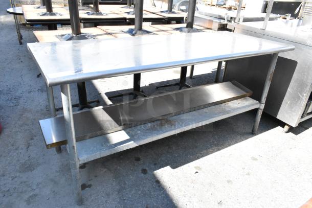 Stainless steel table with metal under shelf, rectangular shape, good condition. Ideal for industrial or kitchen use.