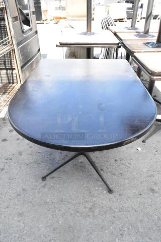 Three dining height tables with metal bases, featuring rectangular and round tops. Slight surface wear visible.