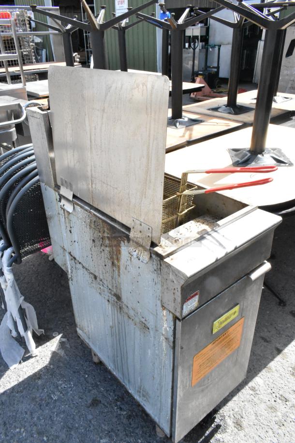 Qualite QL-9/NG stainless steel floor fryer, natural gas, 90,000 BTU, with 2 metal fry baskets and splash guard. Used condition.