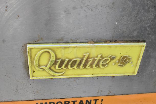 Qualite QL-9/NG stainless steel commercial fryer with label. Model details on yellow tag; natural gas, 90,000 BTU.