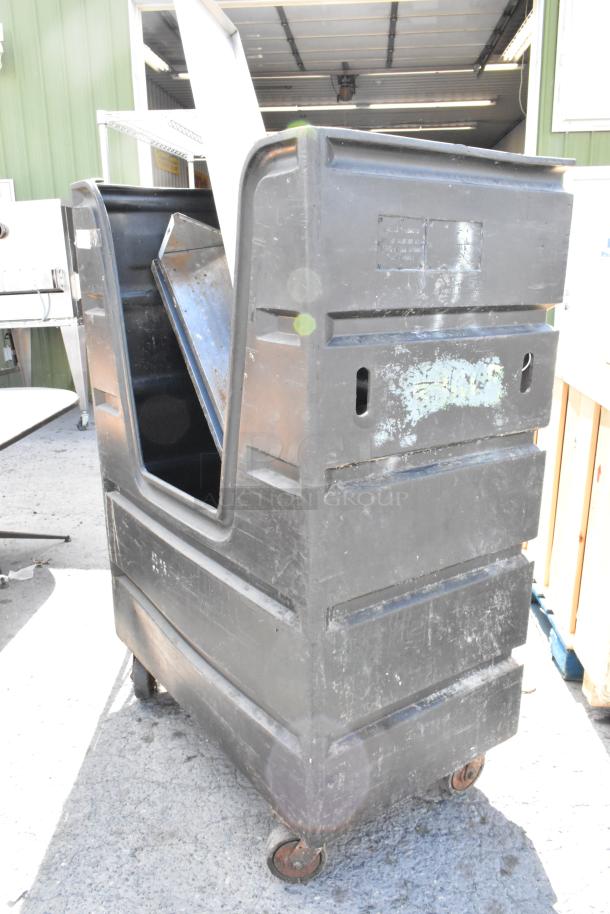 Black poly truck on commercial casters, showing wear, comes with contents. Ideal for industrial or commercial use.