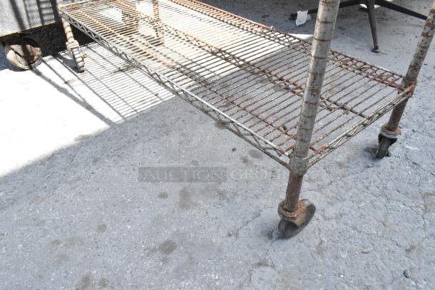 Chrome finish 5-tier wire shelving unit on commercial casters, showing signs of rust. Buyer must dismantle.