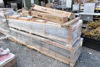 Pallet of 9 new scratch and dent items, including boxed patio umbrellas, labeled "Lancaster," plastic-wrapped, outdoors.