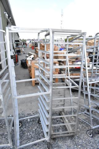 2 metal commercial pan transport racks with commercial casters; durable, stable condition, ideal for kitchen use.