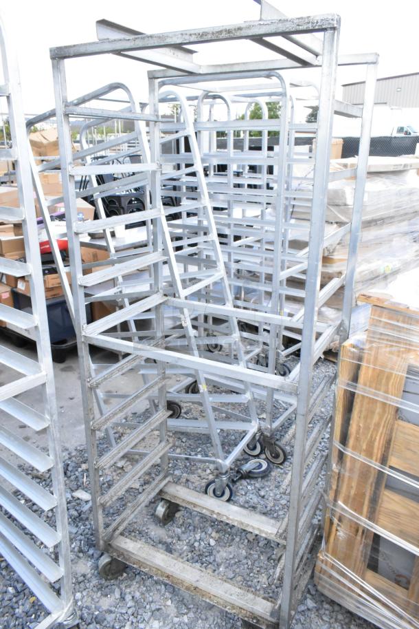 2 metal commercial pan transport racks with multiple shelves on heavy-duty casters; used condition.