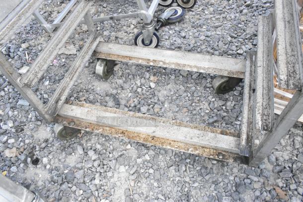 2 metal commercial pan transport racks on casters, worn condition, designed for industrial use, dual units included.