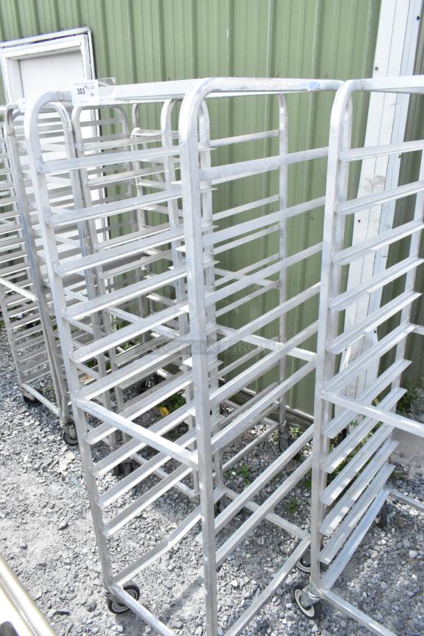 2 metal commercial pan transport racks on commercial casters, sturdy, ideal for kitchen use, good condition.