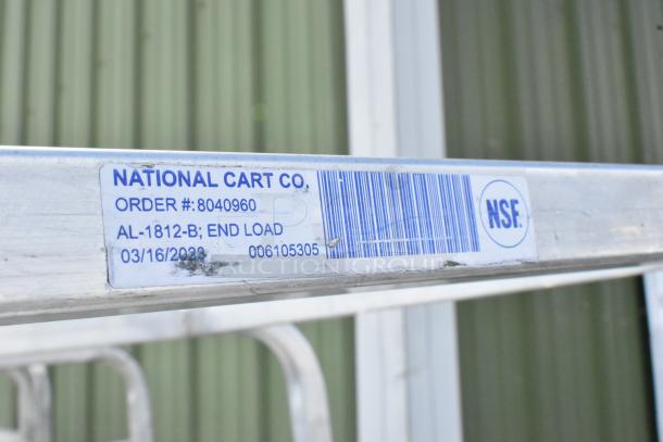 2 metal commercial pan transport racks on casters; label shows National Cart Co., model AL-1812-B, NSF certified.