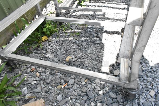 2 metal commercial pan transport racks on casters, in good condition, suitable for commercial kitchen use.