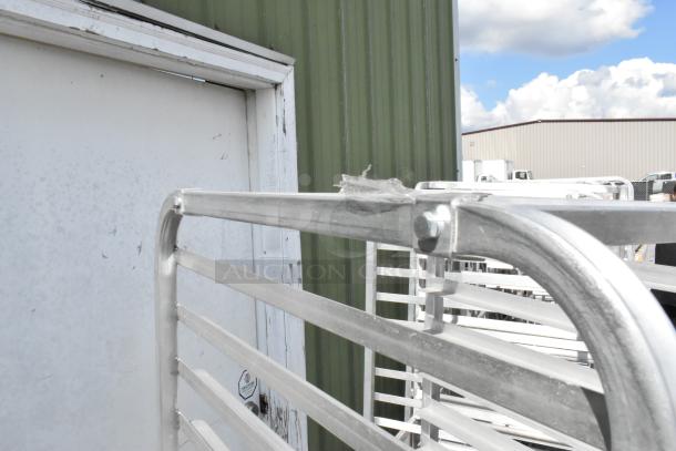 Two metal commercial pan transport racks with casters, sturdy condition, suitable for kitchen or industrial use.