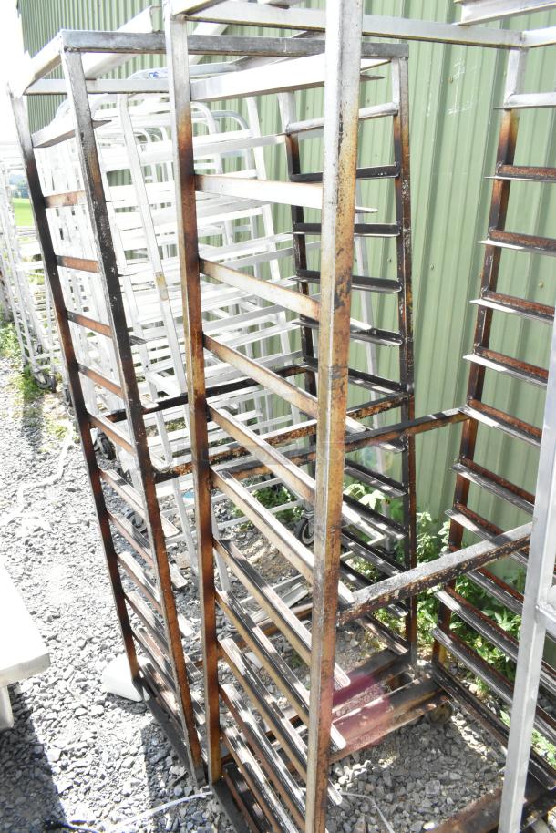 2 metal commercial pan transport racks with commercial casters, used condition, rack oven guide included.