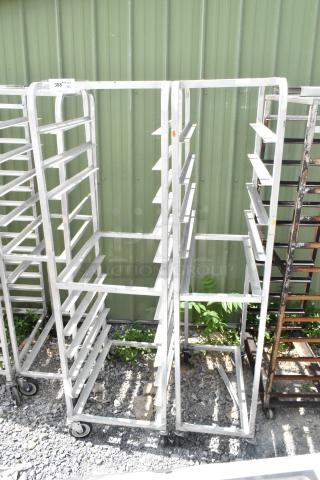 2 metal commercial pan transport racks on casters, durable and spacious, ideal for bakery or kitchen use.